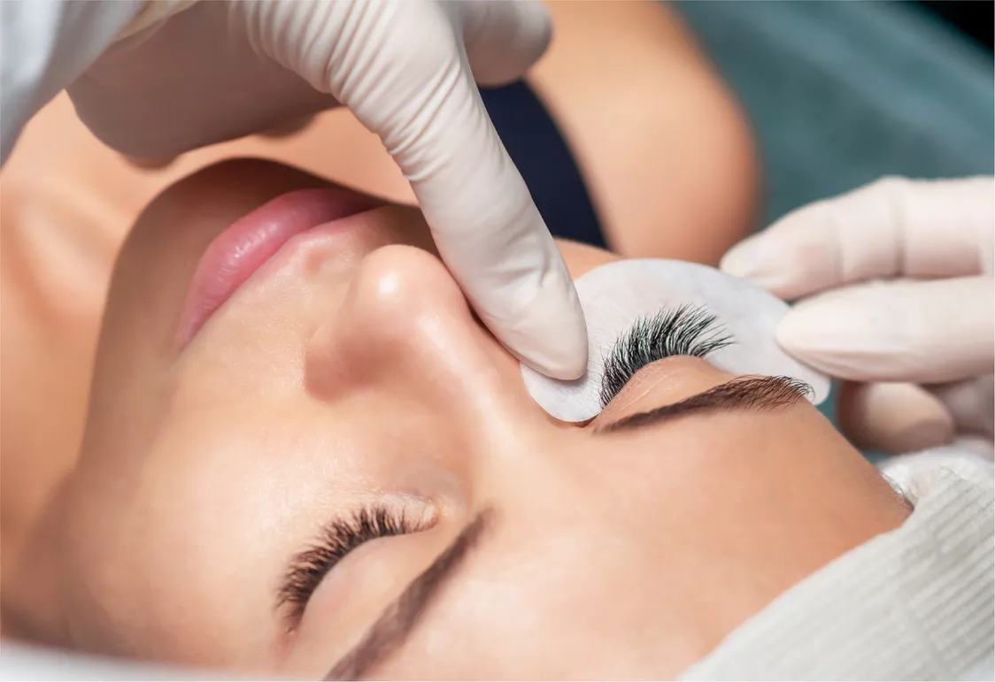 An eye pad being placed before an eyelash extension treatment