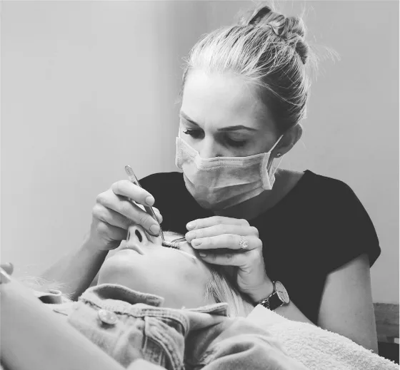 Carolyn Cowley applying eyelash extensions