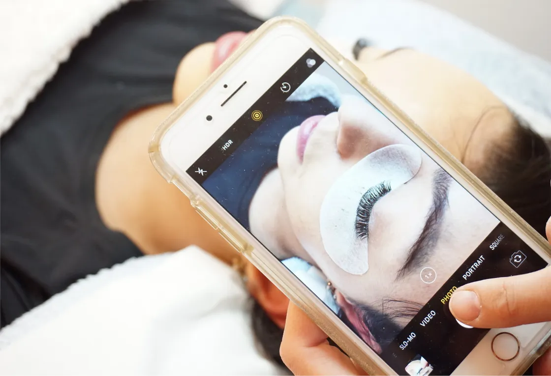Photographing a client's finished lashes on a phone