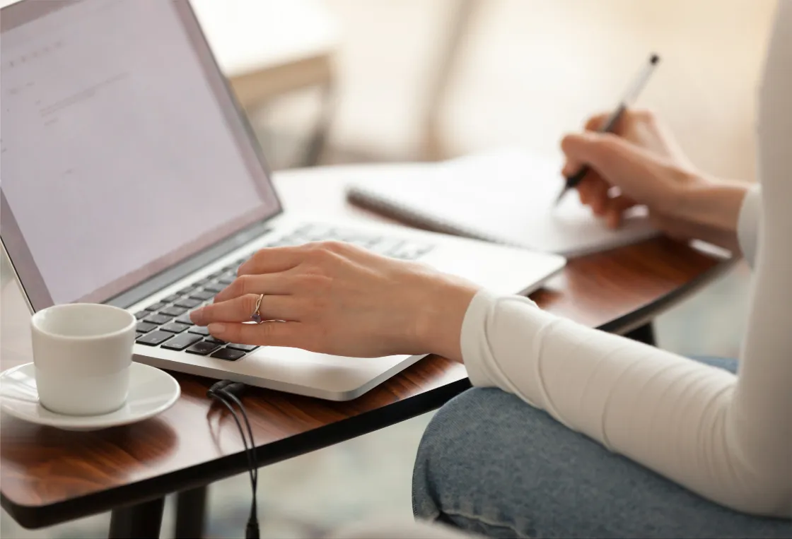 Taking notes at a laptop